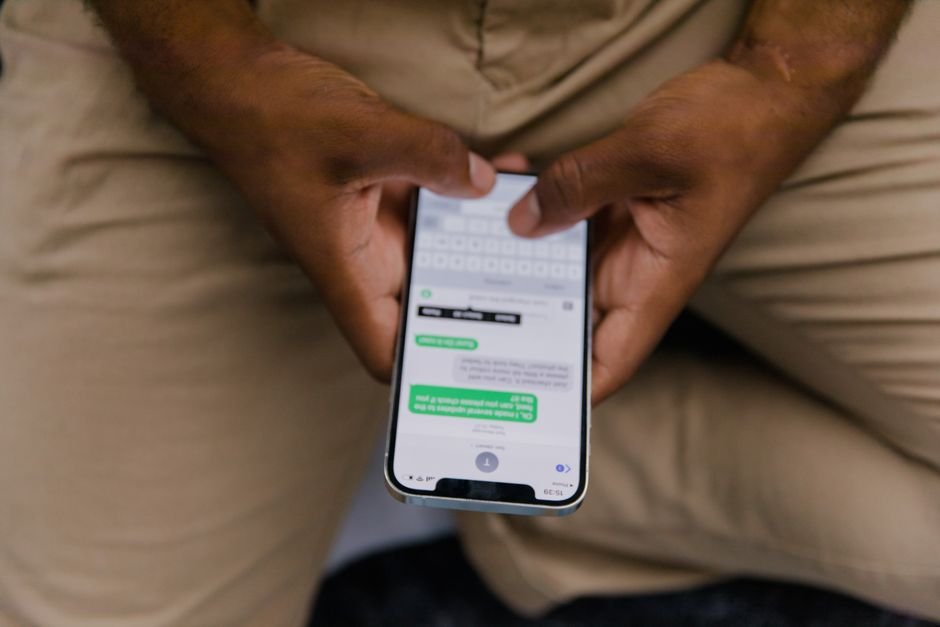 Person typing a social media comment on a smartphone, the way Bangladeshi users mix Bangla and English