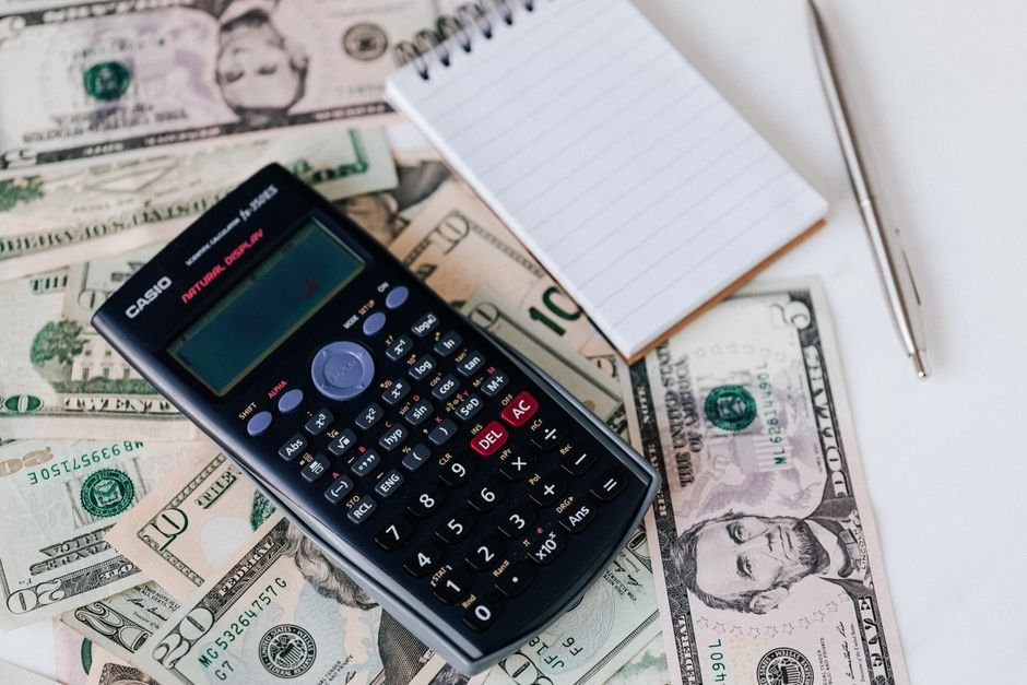 Calculator and money on a desk โ working out AI social media moderation cost