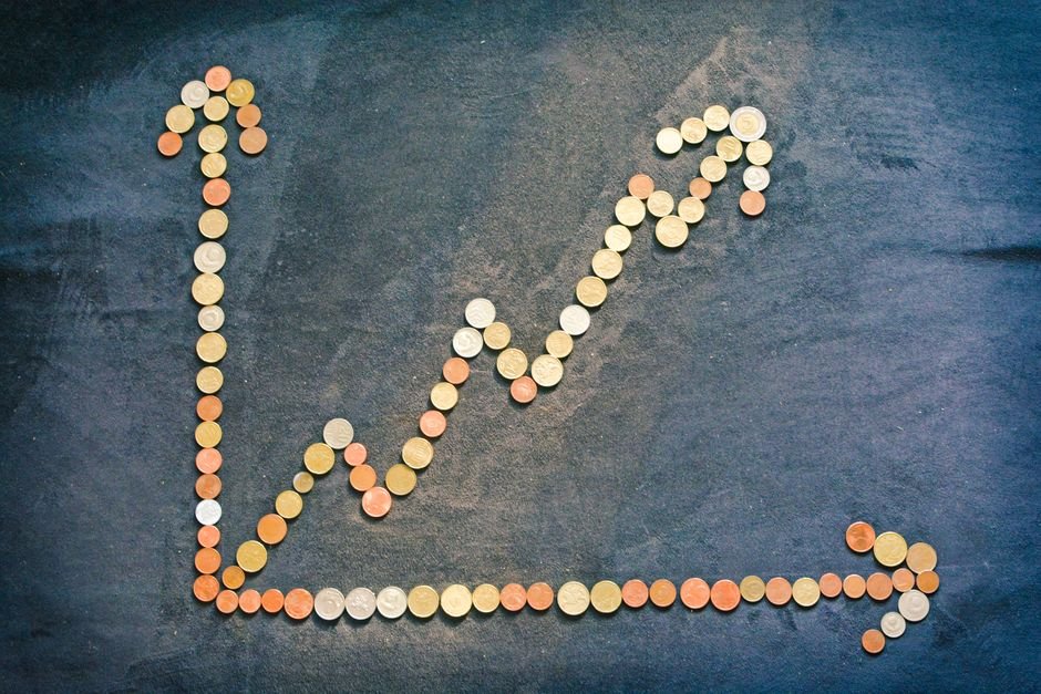 Coins and growth chart โ ROI of AI social media moderation spending