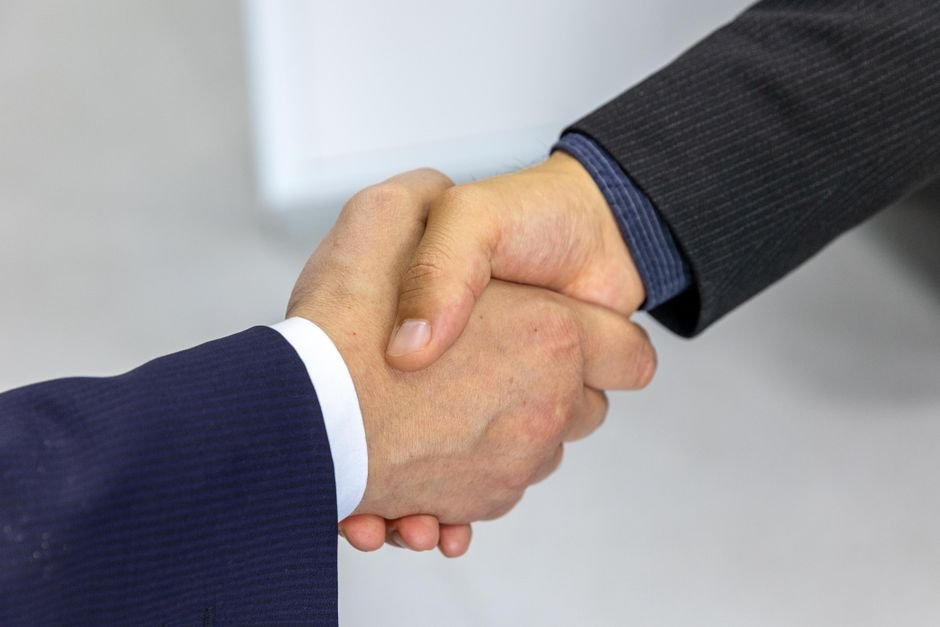 Business handshake over a contract โ ask moderation vendors the data-ownership questions before signing
