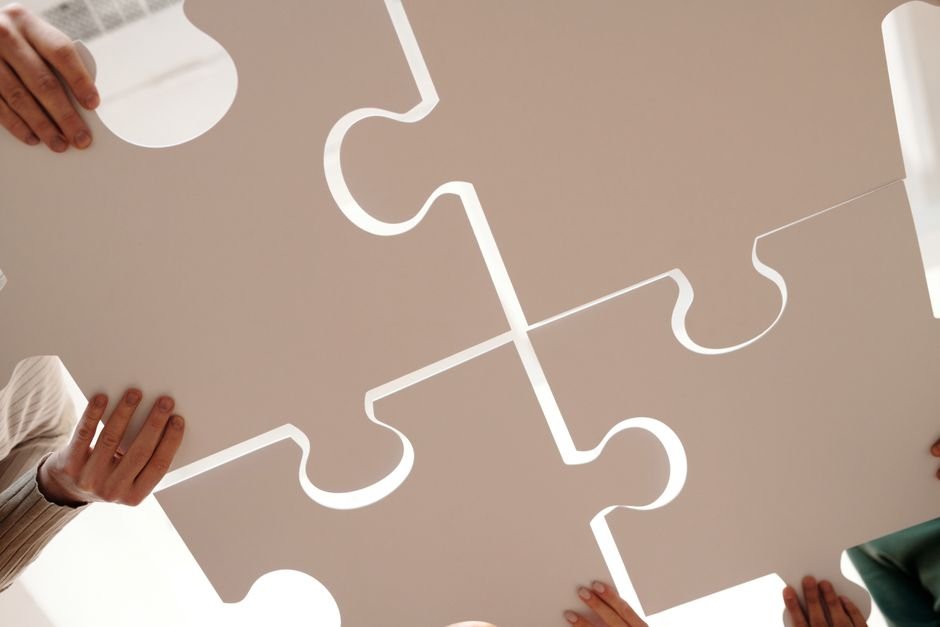 Hands fitting puzzle pieces together - OPatch and Datapatch completing a full Oracle Release Update
