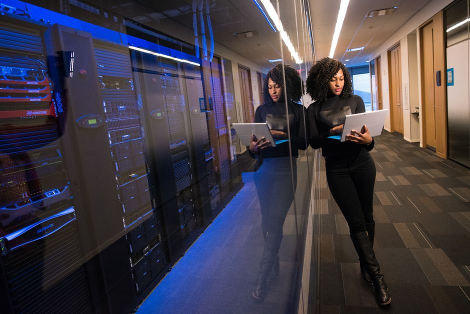 Engineer working on a laptop inside a data centre, building in-house Sovereign AI capability